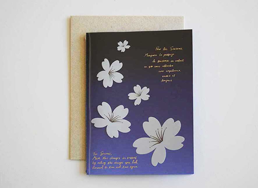  Luxury greeting card with dark violet hue background, cascading white cherry blossom and curated messages delicately printed with gold hot foil stamp.