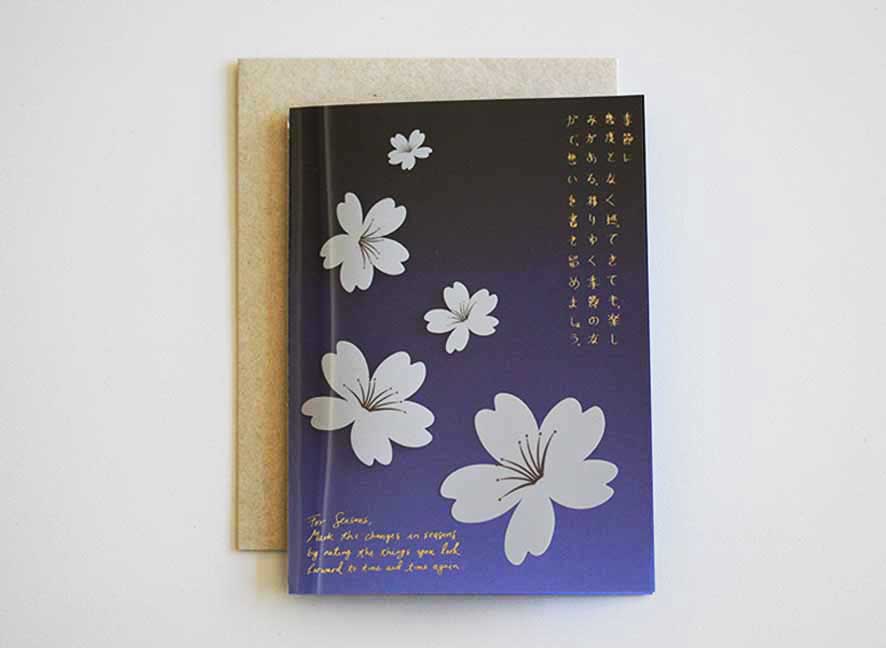  Luxury greeting card with dark violet hue background, cascading white cherry blossom and curated messages delicately printed with gold hot foil stamp.