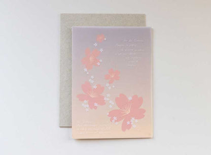  Luxury greeting card. Two-ply card with a translucent light pink cover printed with small white cherry blossoms that cascade throughout the paper. Interior is cream cardstock printed with blue skies larger and large white cherry blossoms that have been pressed into the paper. English-French version.
