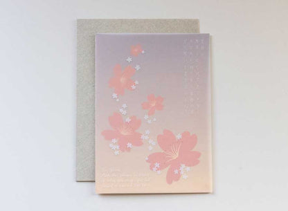  Luxury greeting card. Two-ply card with a translucent light pink cover printed with small white cherry blossoms that cascade throughout the paper. Interior is cream cardstock printed with blue skies larger and large white cherry blossoms that have been pressed into the paper. English-Japanese version.